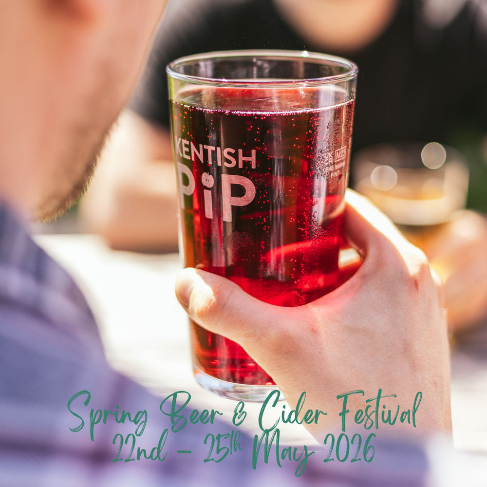 Person holding a glass of red liquid with 'Kentish Pip' branding at a Spring Beer & Cider Festival event.